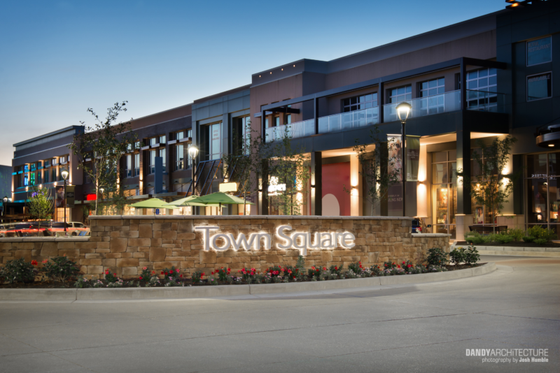 Dusk photo of lit town square.