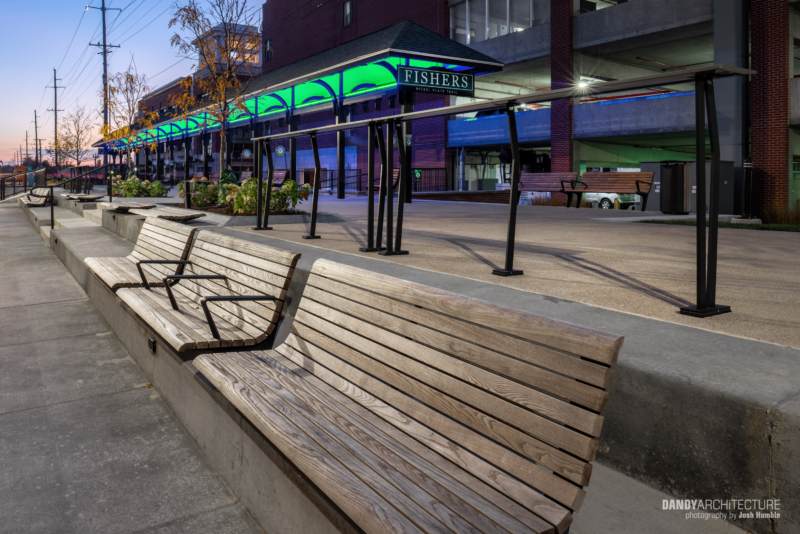 Outdoor park at dusk with benches.
